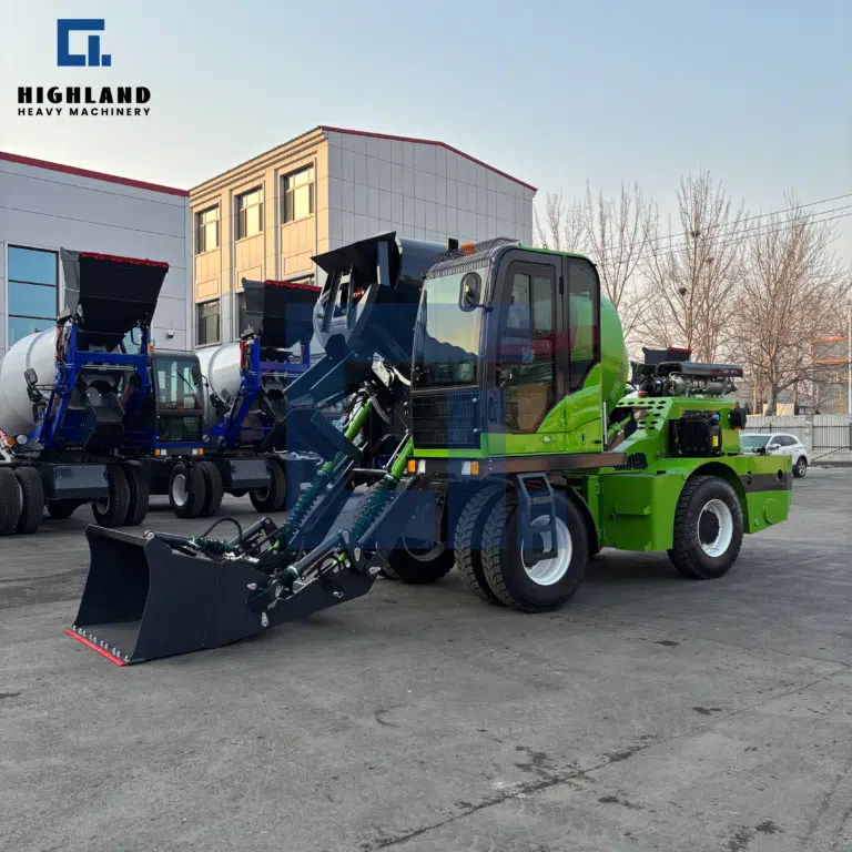 HIGHLAND HEAVY MACHINERY green self-loading concrete mixer undergoing final testing in factory yard, featuring front loading bucket and operator cabin for efficient on-site concrete production