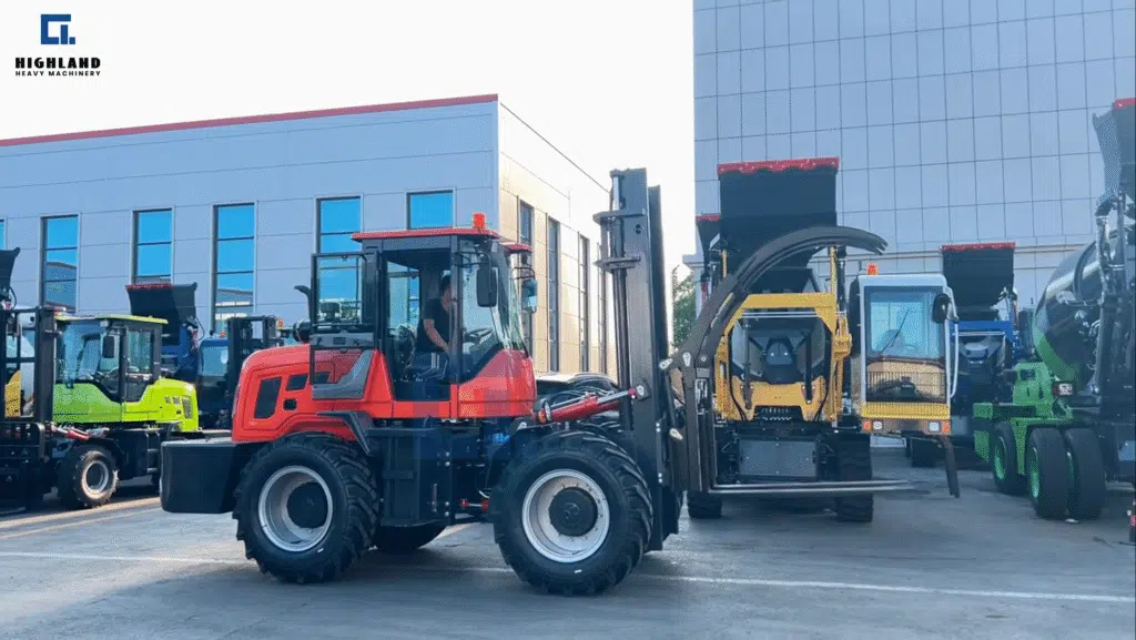 HIGHLAND HEAVY MACHINERY HIC 5.0 red rough terrain forklift with heavy-duty tires and lifting forks, parked in factory yard for heavy lifting and material handling on construction and mining sites