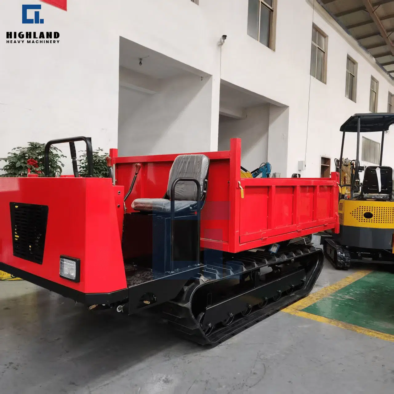 Highland Heavy Machinery red HILD 3.0 crawler dumper with operator seat, parked in workshop for heavy-duty construction and farm material transport