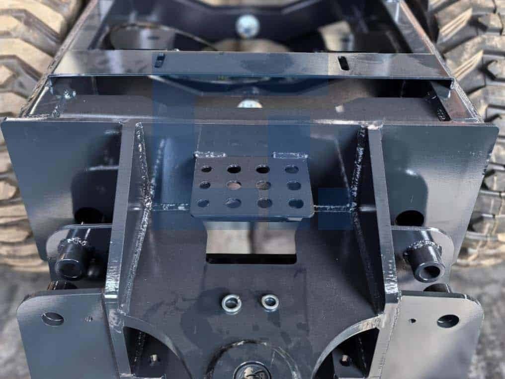 Close-up of HIGHLAND HEAVY MACHINERY HILT 50 backhoe loader 8-shaped rear support bracket, showing heavy-duty steel plating, reinforced welding, and precise bolt-on mounting points for secure backhoe attachment