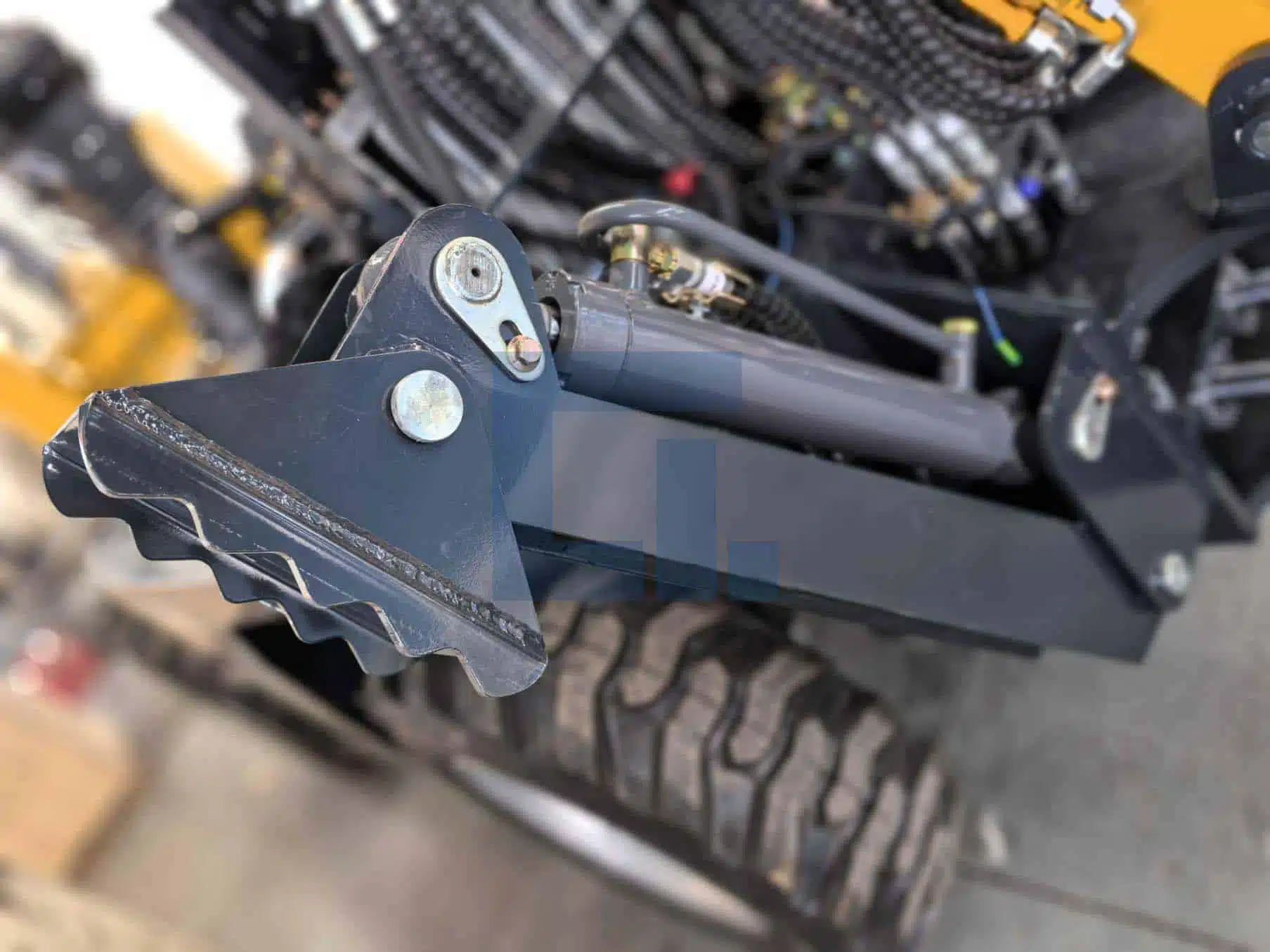 Close-up of HIGHLAND HEAVY MACHINERY HILT 50 backhoe loader thickened stabilizer leg, featuring heavy-duty steel foot pad with serrated edge and reinforced pin connection for secure ground grip and machine stability during excavation