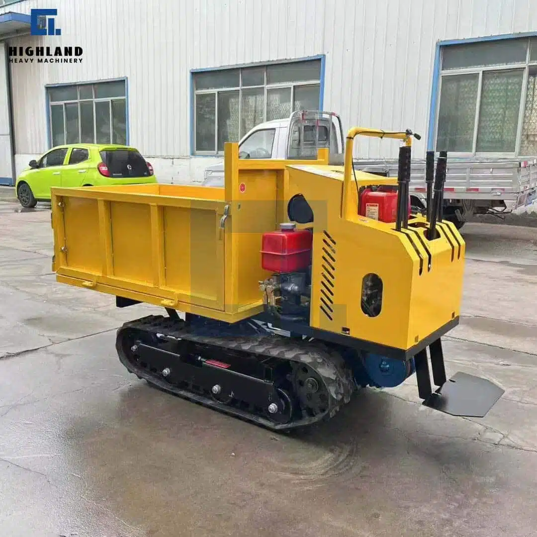 Highland Heavy Machinery yellow stand-on crawler dumper HILD 1.5, 1.5 ton capacity, showing hydraulic controls and track system in outdoor yard