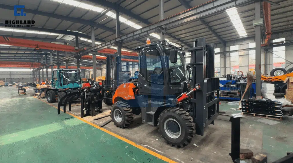 HIGHLAND HEAVY MACHINERY rough terrain forklift rolling off the assembly line in a factory, featuring a completed blue and orange forklift with heavy-duty tires and lifting forks ready for quality inspection.