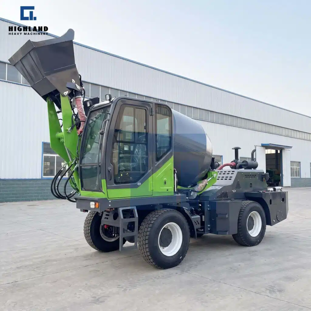 HIGHLAND HEAVY MACHINERY green self loading concrete mixer truck with a high-lift bucket raised high and an enclosed operator cabin, parked outdoors in a factory yard.